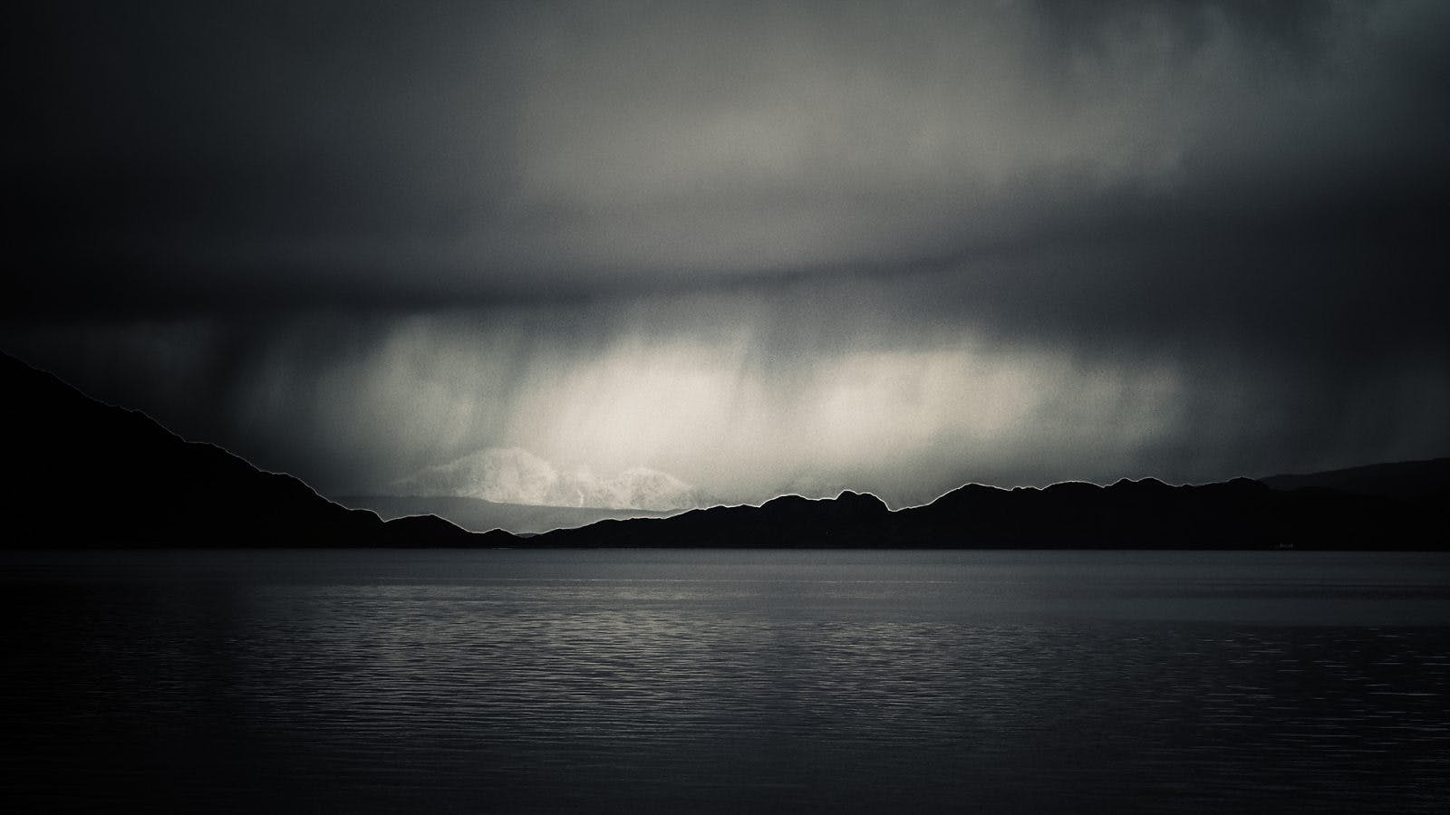 Storm over a Scottish Loch. On bikerafting adventures in Scotland, you never know what kind of weather you&apos;ll find.