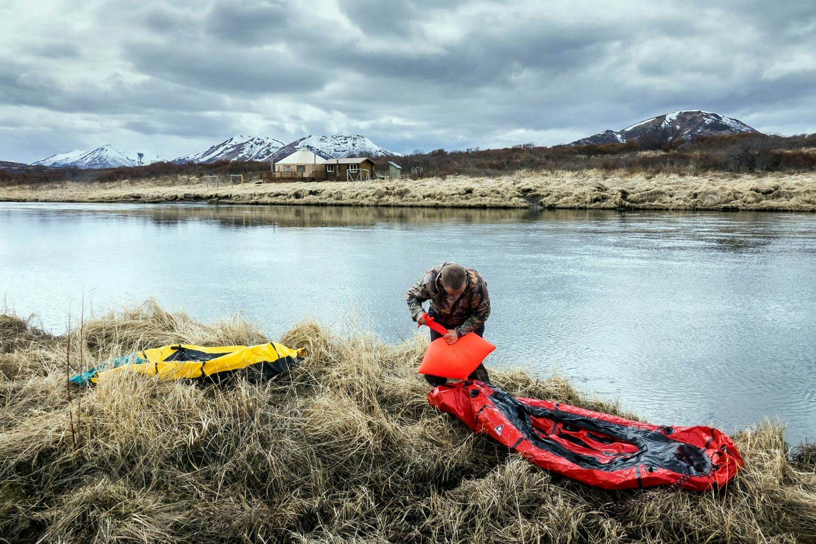 Bjorn Dihle inflates his packraft at the edge of the Karluk River, after hiking from Larsen Bay to the midpoint of the river; which also served as the take out point on the 130-mile loop.&#xA0;