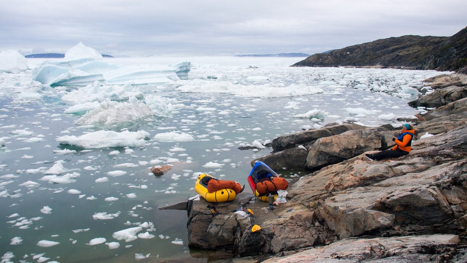 Paddling through a labyrinth of ice near Ilulissat Ice Fjord, West Greenland. We hugged the coastline for 7km while bumping from one ice chunk to the next, to avoid a difficult hiking section on steep and wet rock slabs.