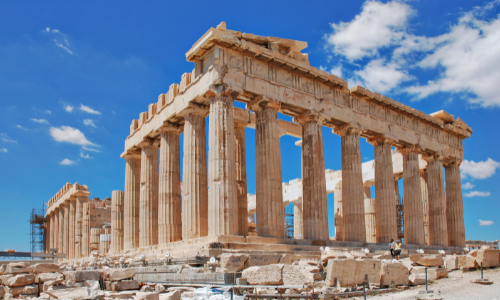 A shot looking up at the Coliseum in Athens with blue skies behind