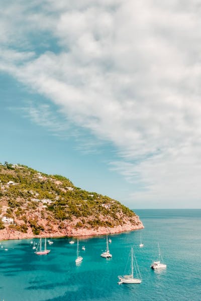 Beach Sant Joan de Labritja, Ibiza. Blue sea and sailboats