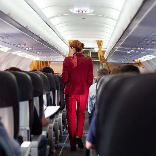 Flight Attendant walking through aisle