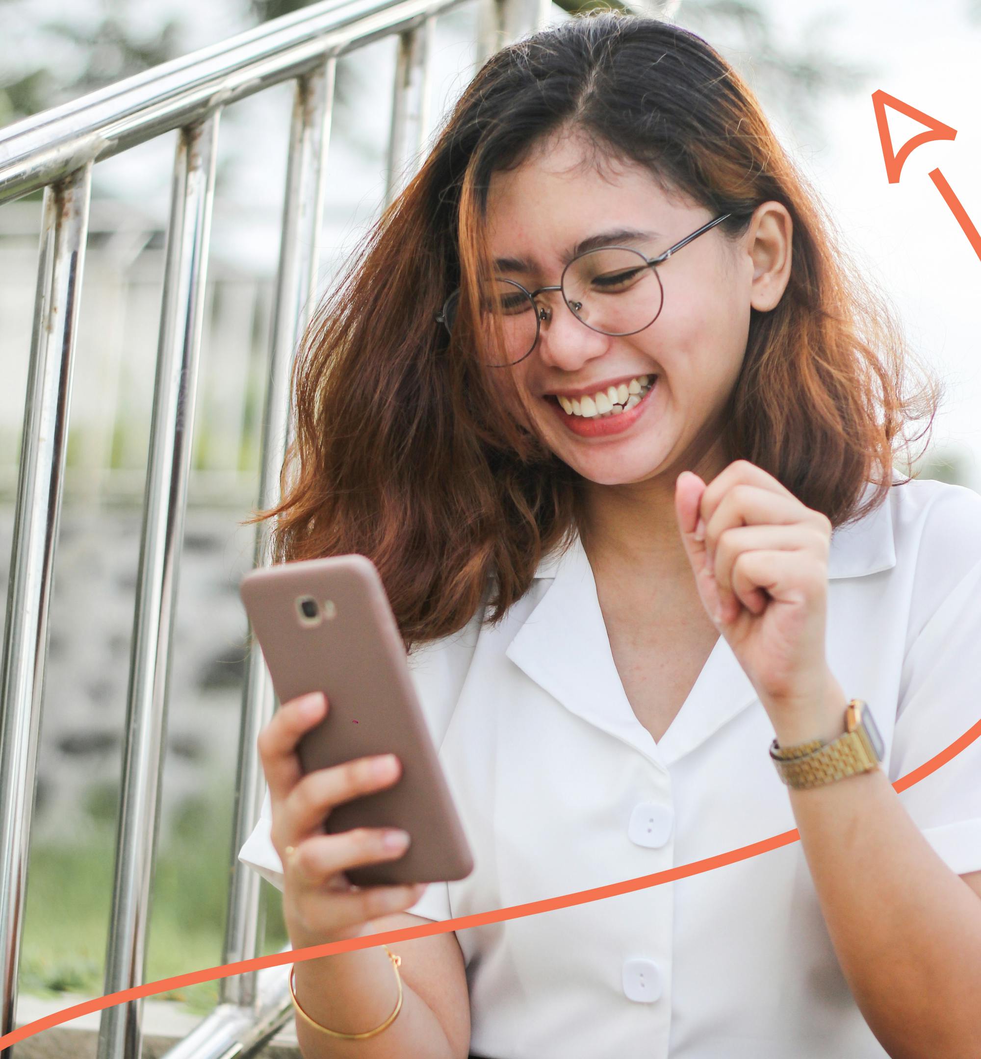 Woman laughing and looking at phone