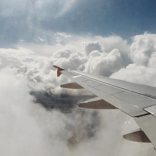 Plane wing with clouds