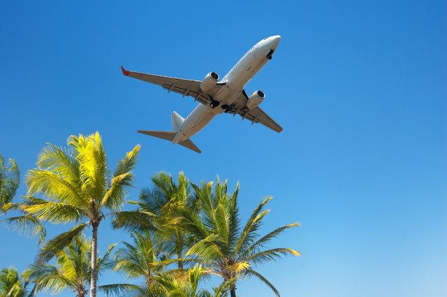 Person booking flights on laptop