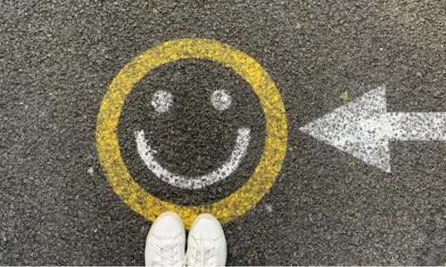 Smiley face on floor and an arrow