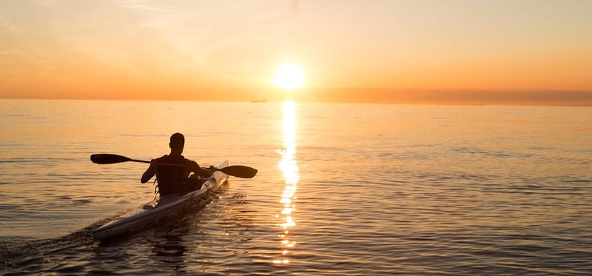 man on a kayak in the sunset