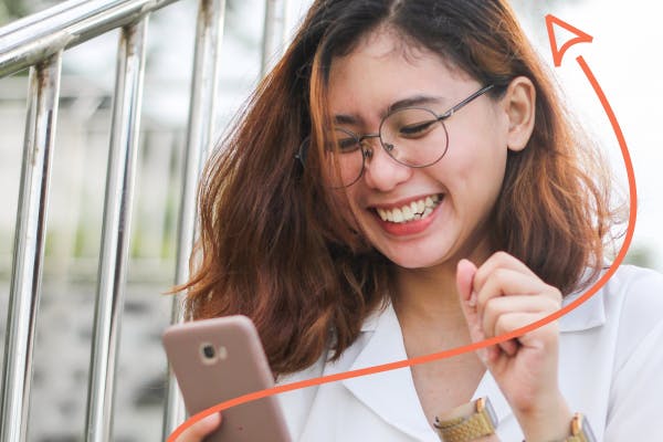 Woman laughing at phone