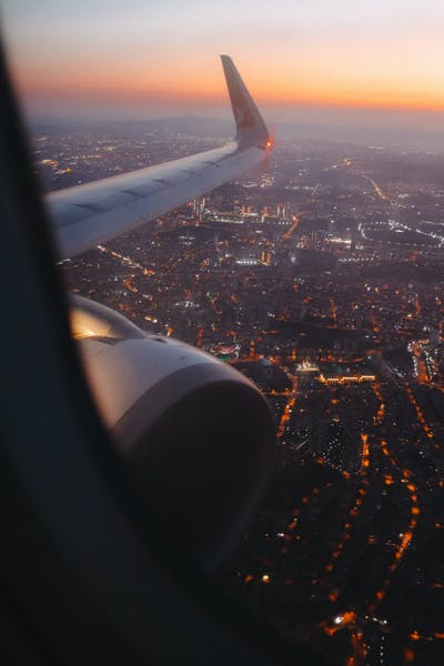View from plane window of city at sunset