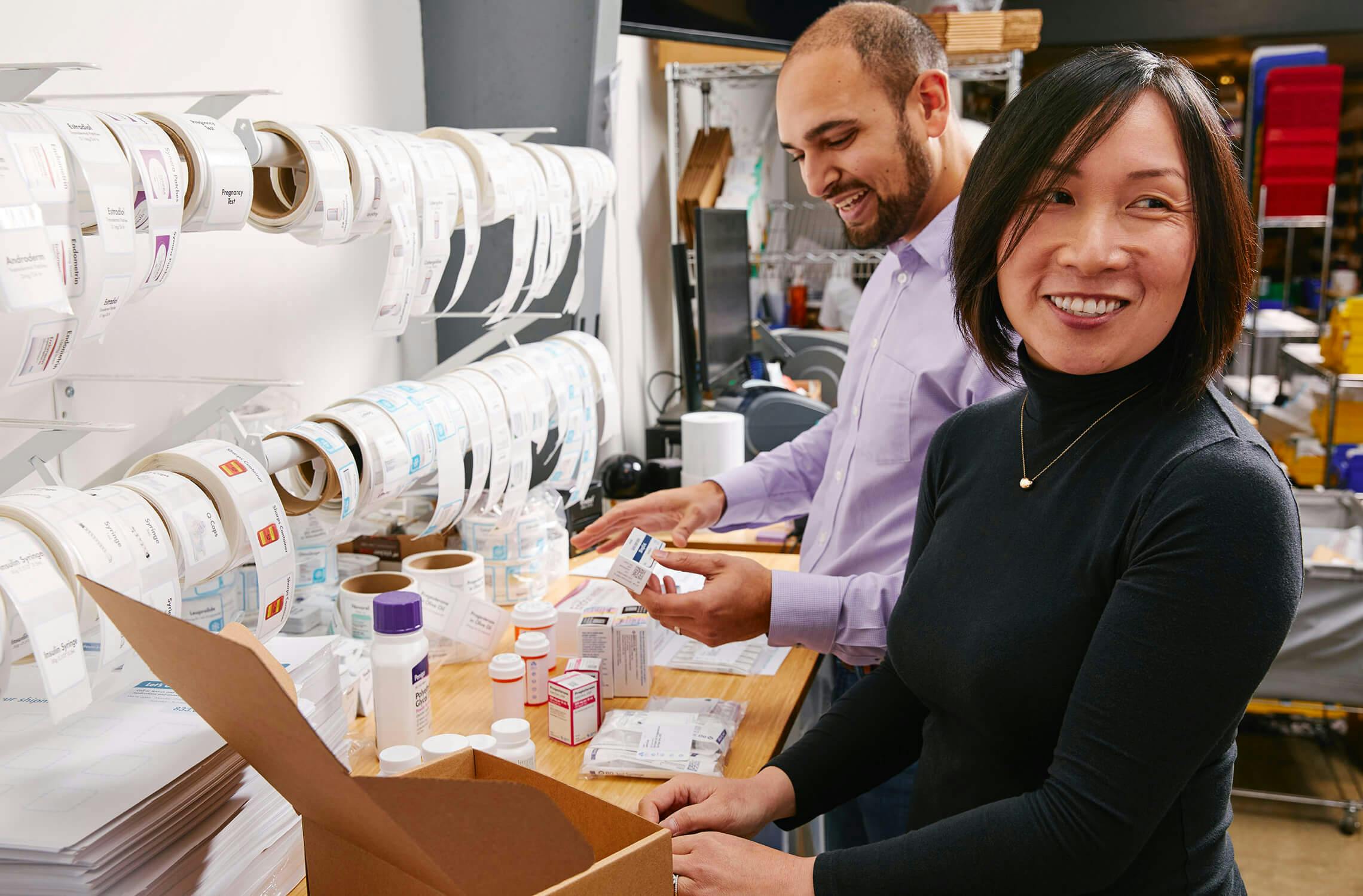 Two Alto Pharmacists in our pharmacy location packing deliveries