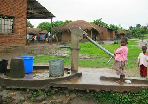 Children in poverty pumping out water