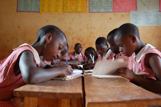 Children in class taking notes