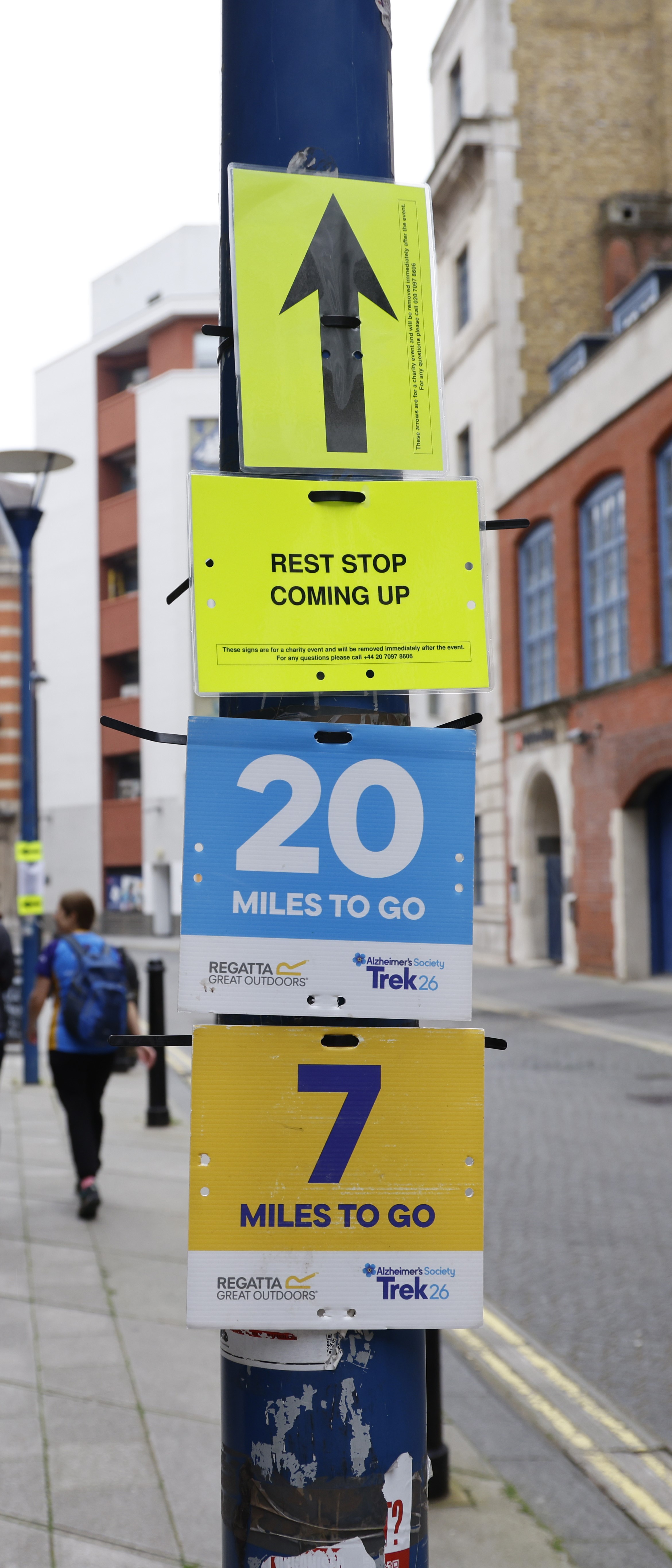 Black arrow on a yellow sign.