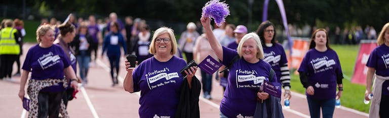 A group of walkers with flags and pom poms