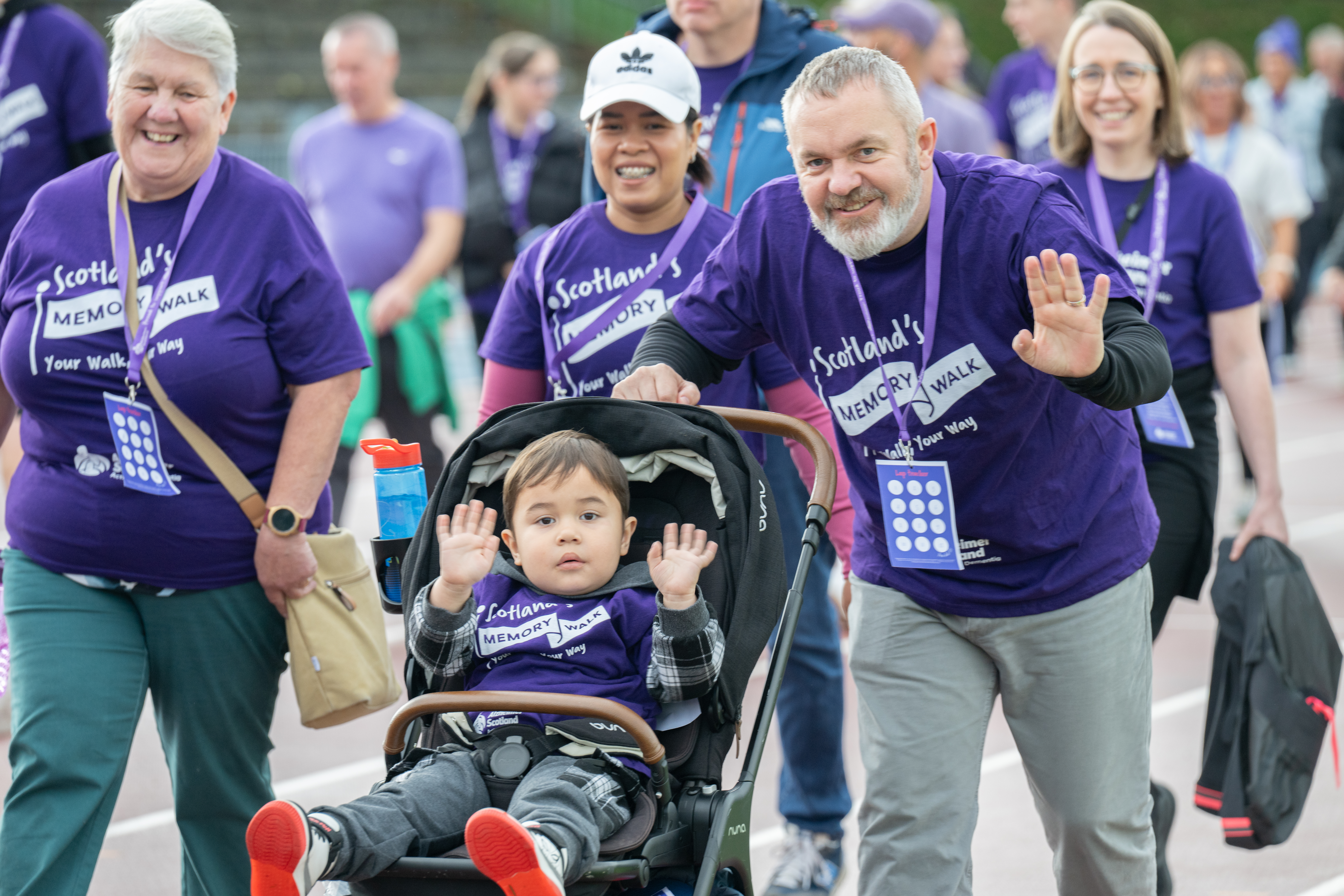 Family pushing a pram completing a Memory Walk