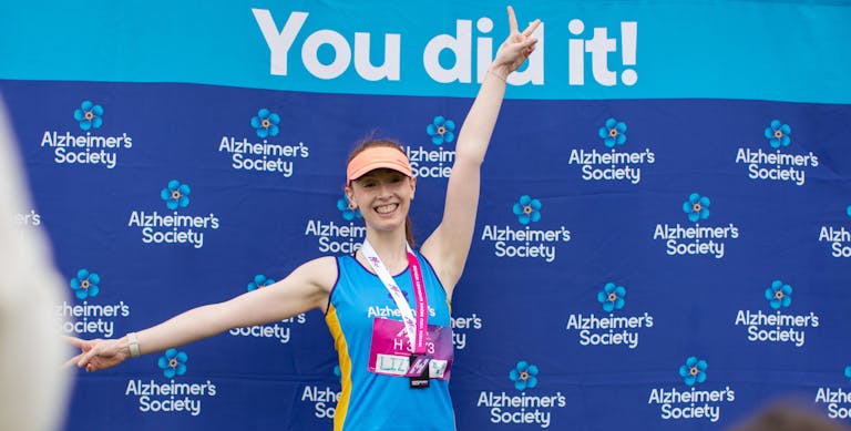 Person smiling in front of banner that says, You did it!