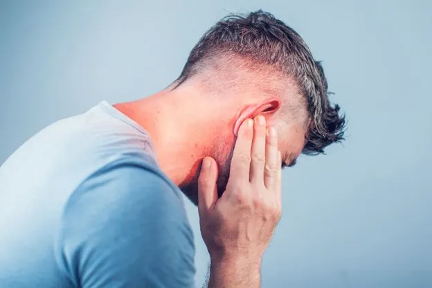 Man holding right ear due to earache in Lely, Marco Island and East Naples FL