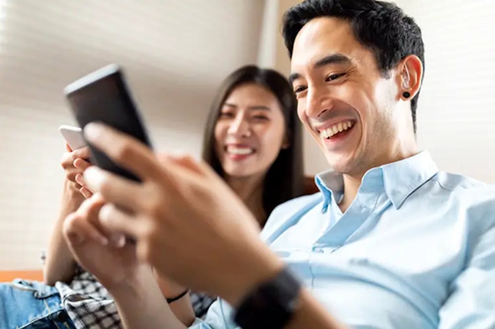 Young man with hearing aids spending time with his girlfriend.