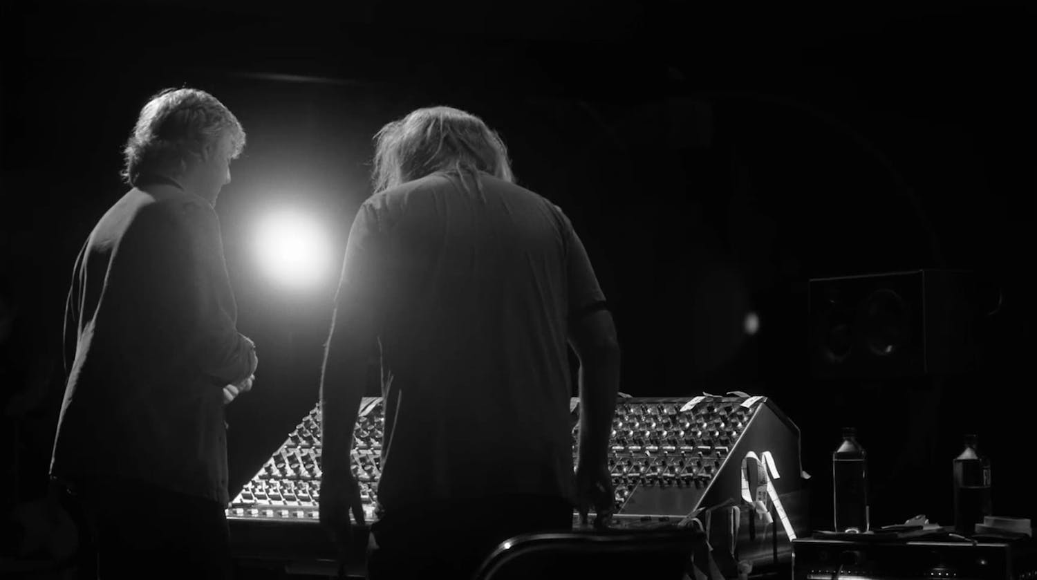 Paul McCartney and man in front of a mixing board