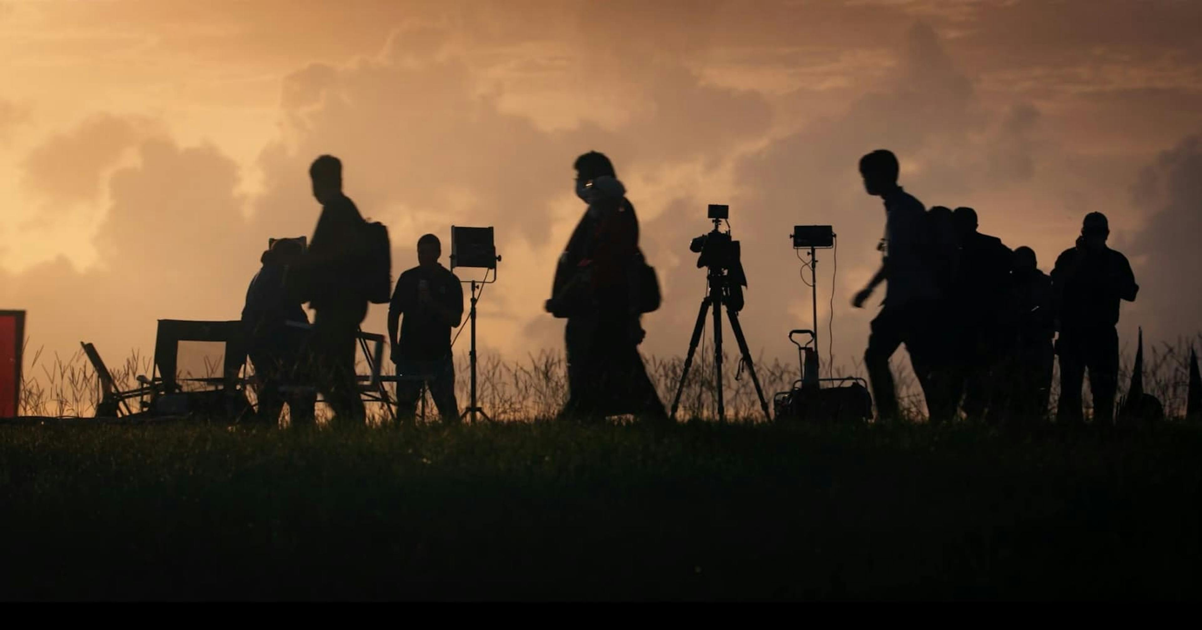 People on a field with cameras