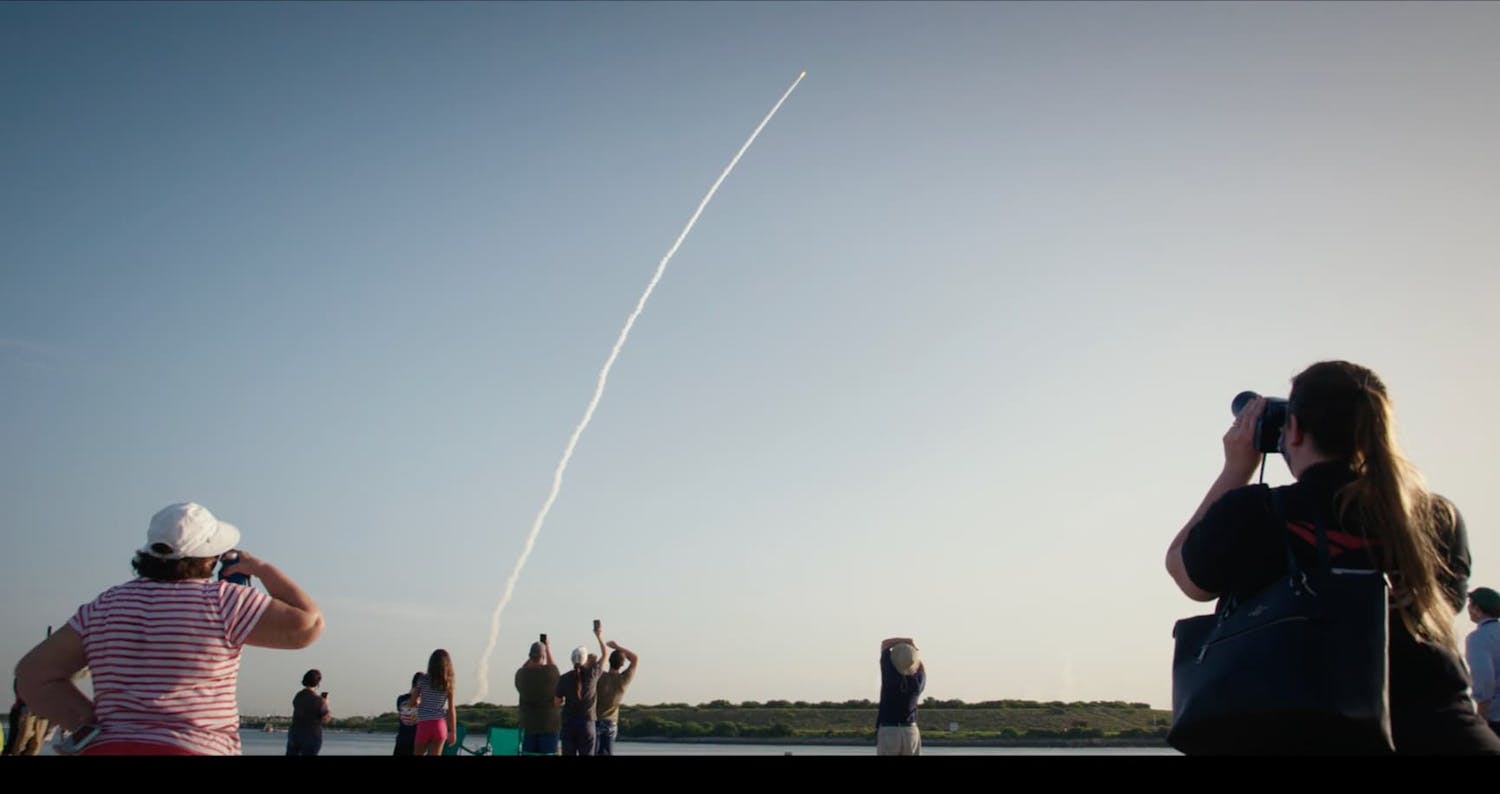 People watching rocket take off