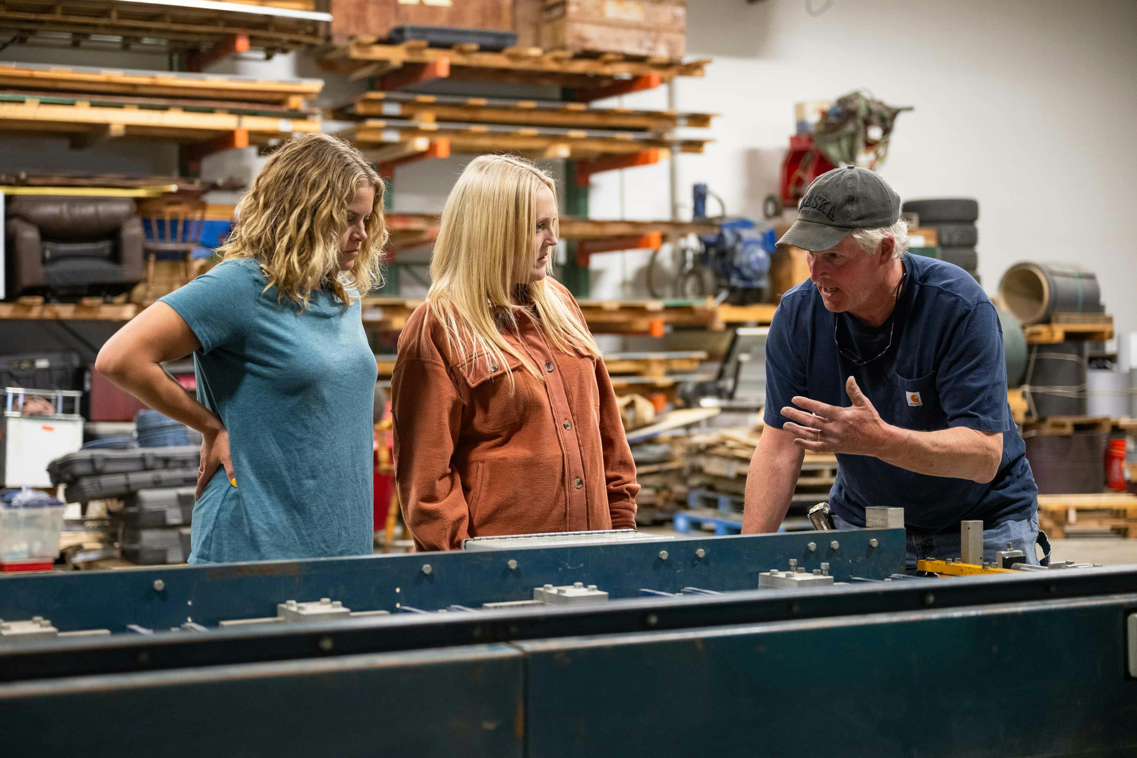 Two women talking to builder
