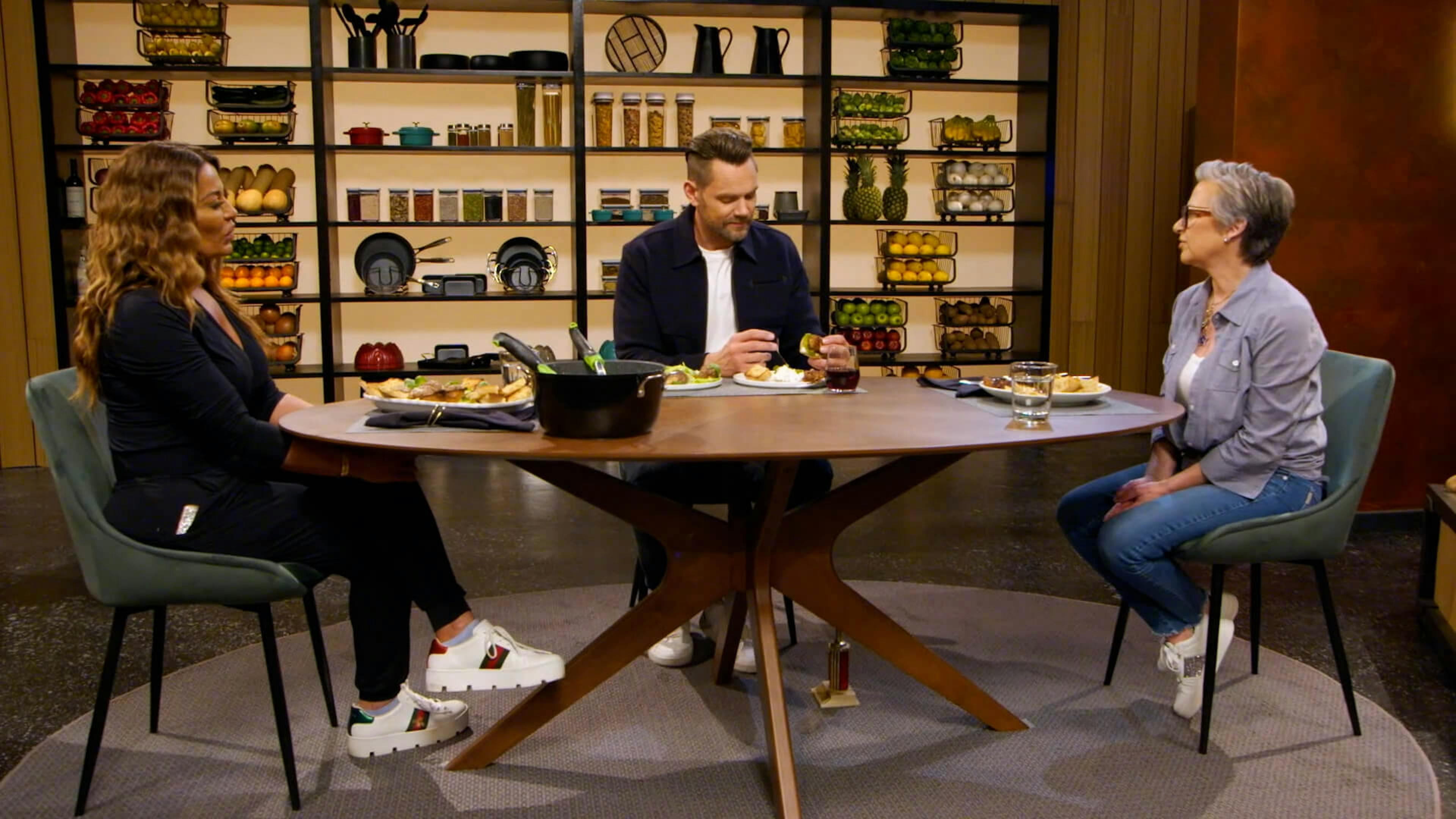 Three people sat around a table