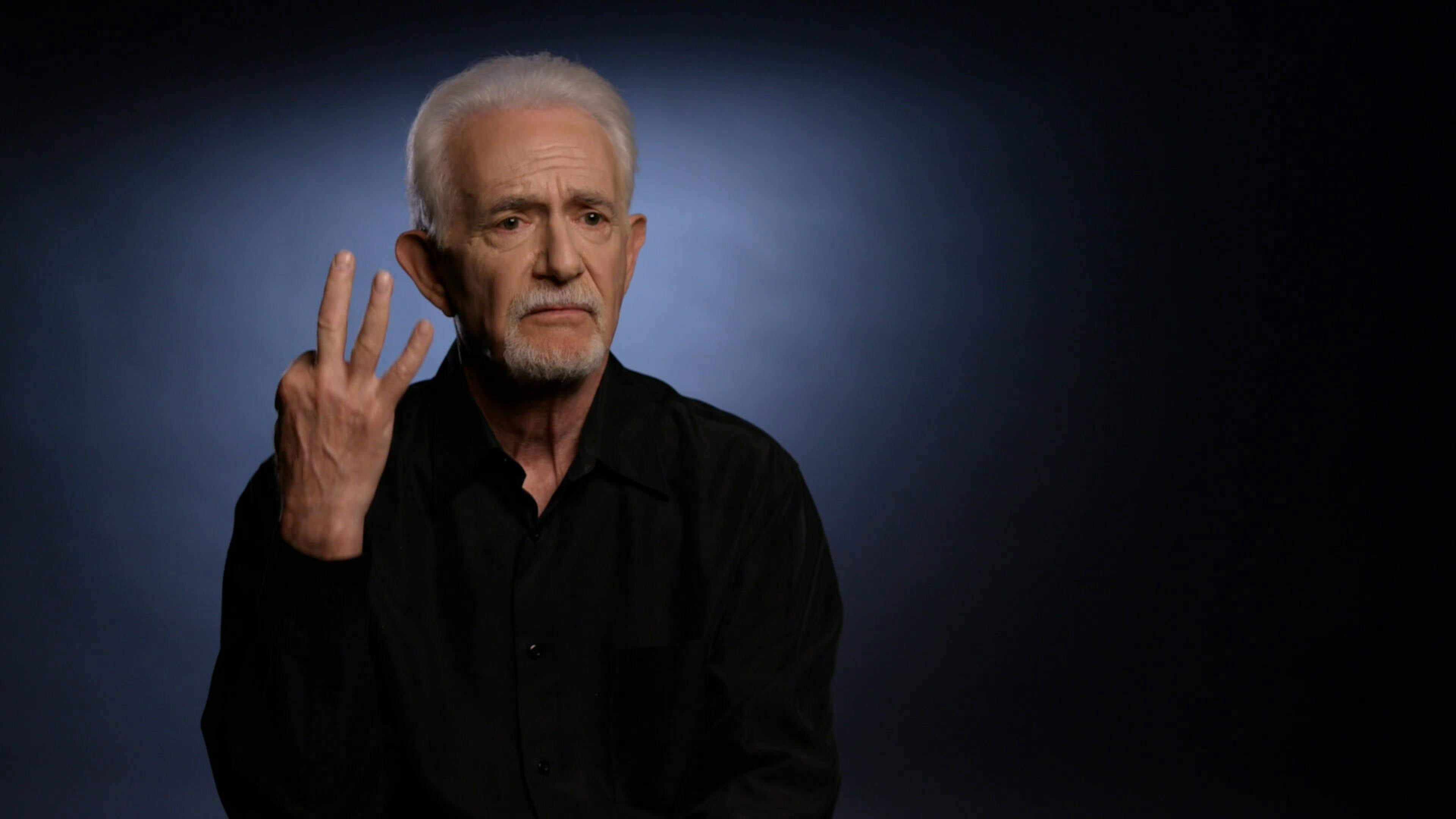 Man holding three fingers up to camera