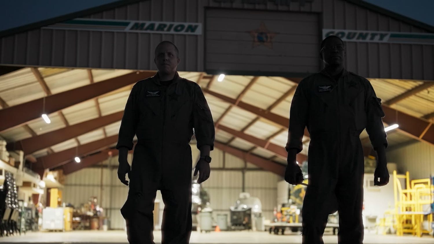 Two men stood in front of warehouse