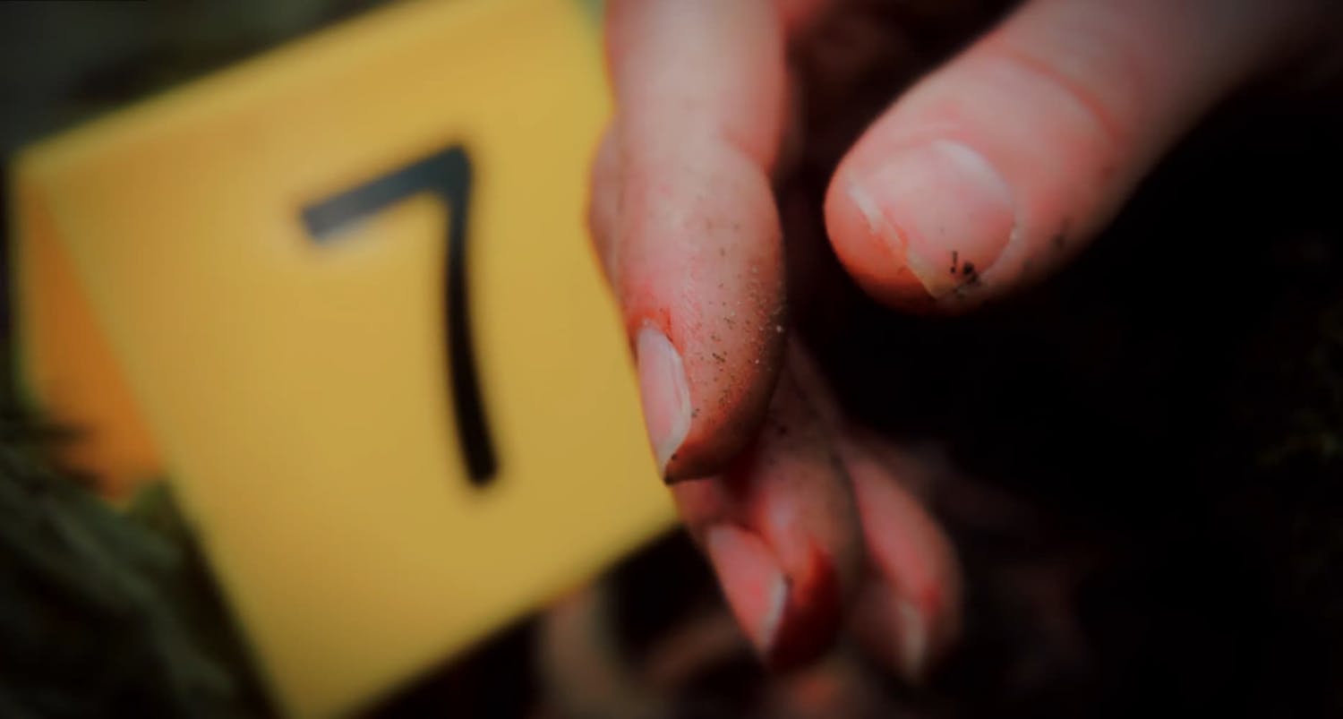 Hand in front of police evidence marker