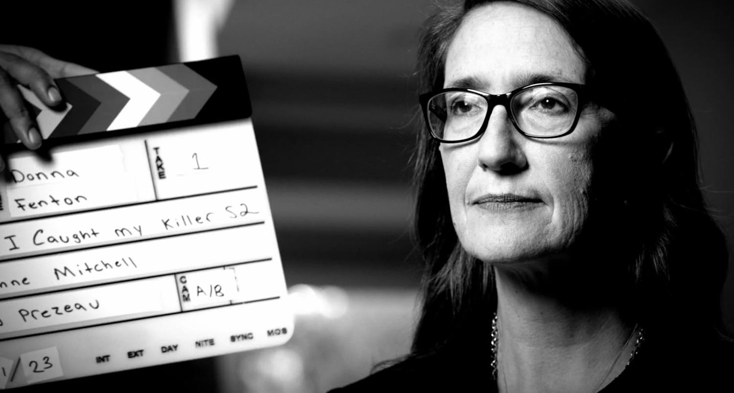 Woman with clapperboard next to face