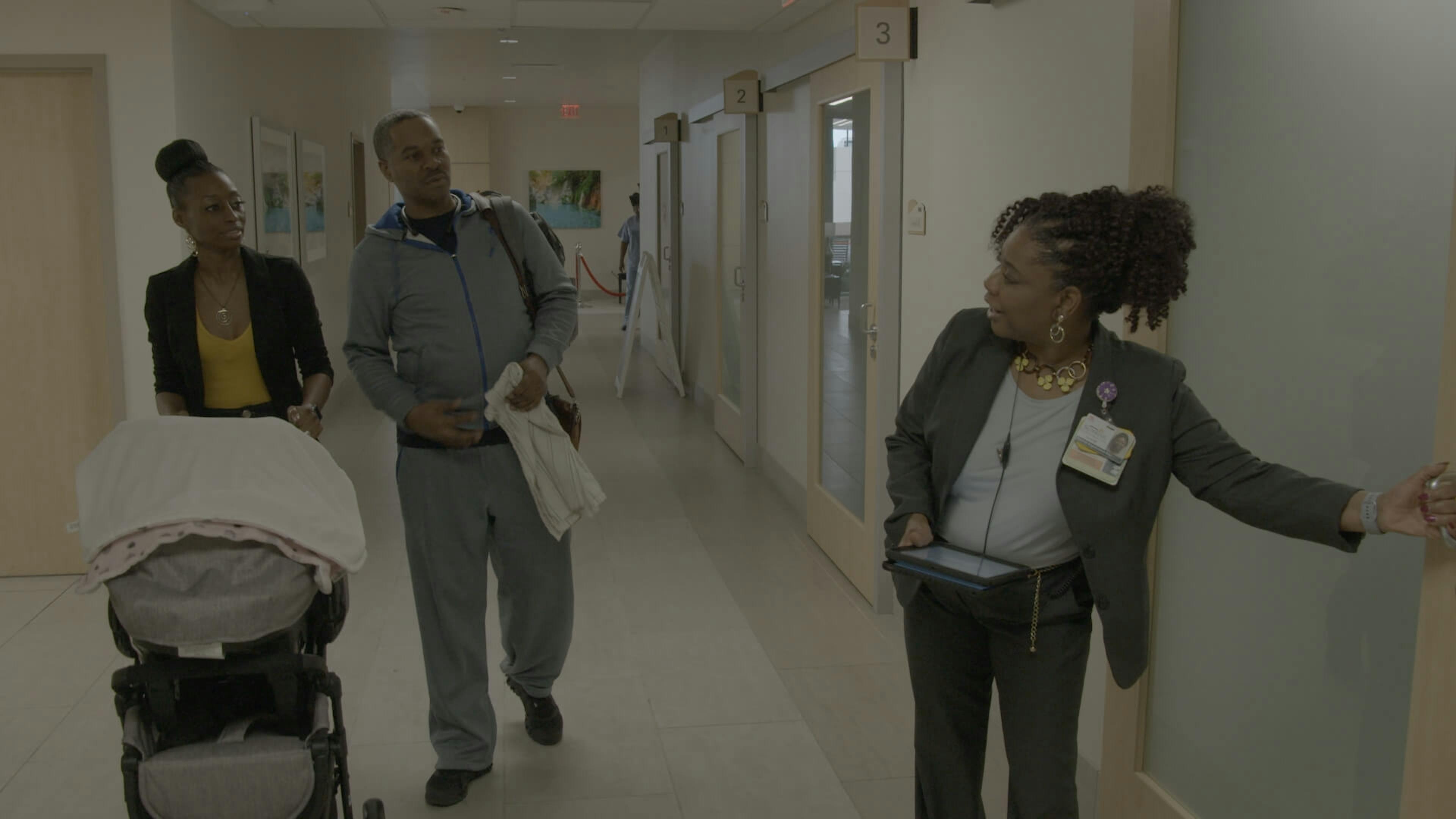 Couple walking through hallway with pram