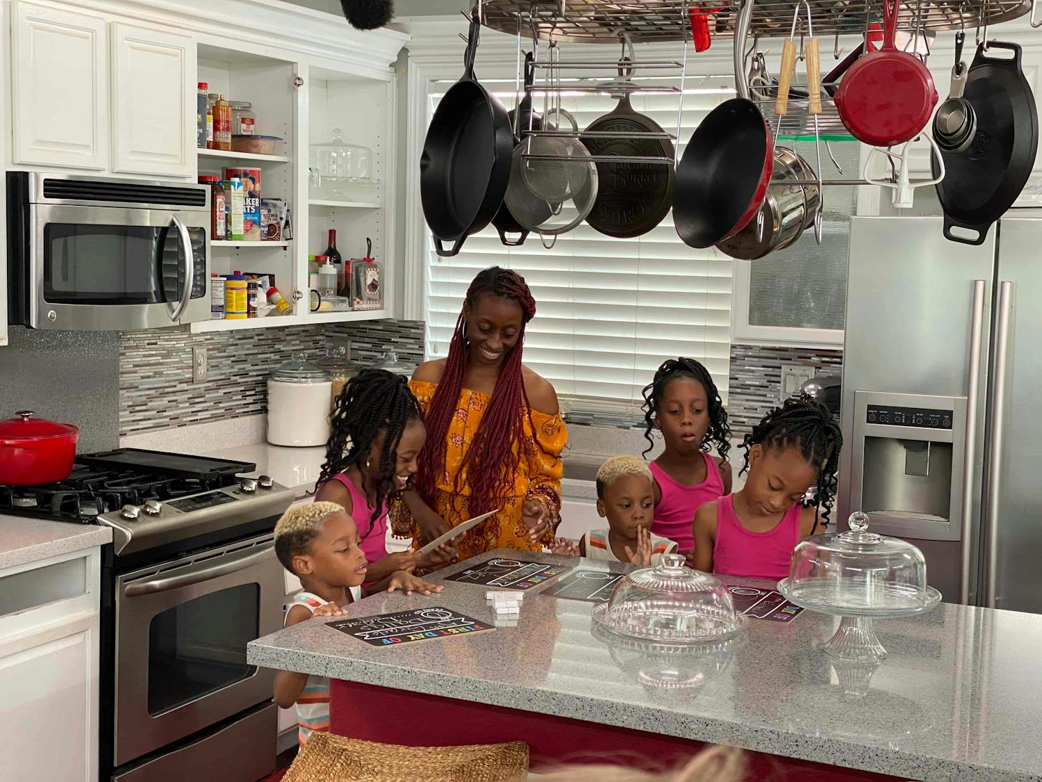 Mother and daughters stood in kitchen