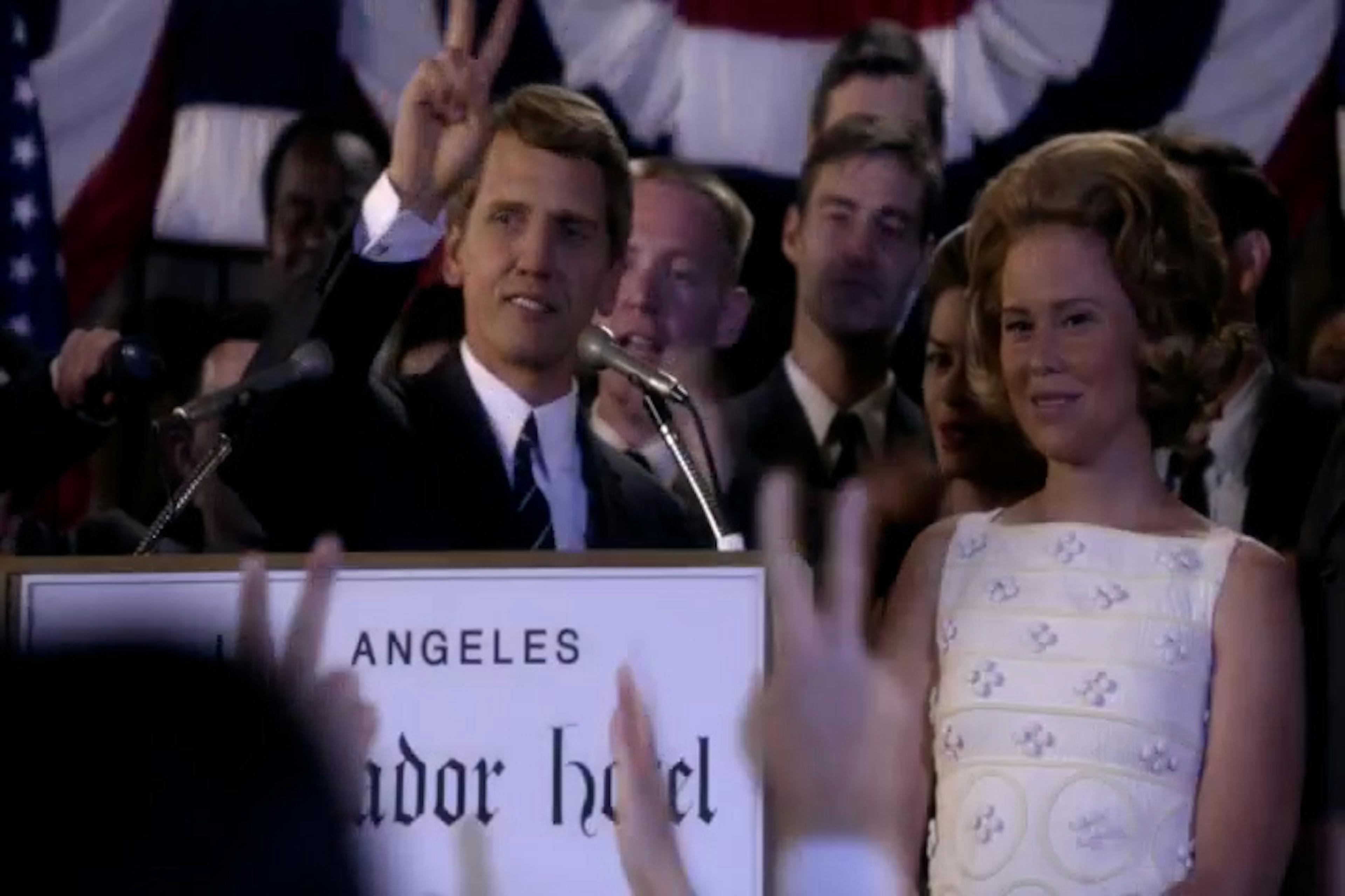 Man and woman stood at lectern talking