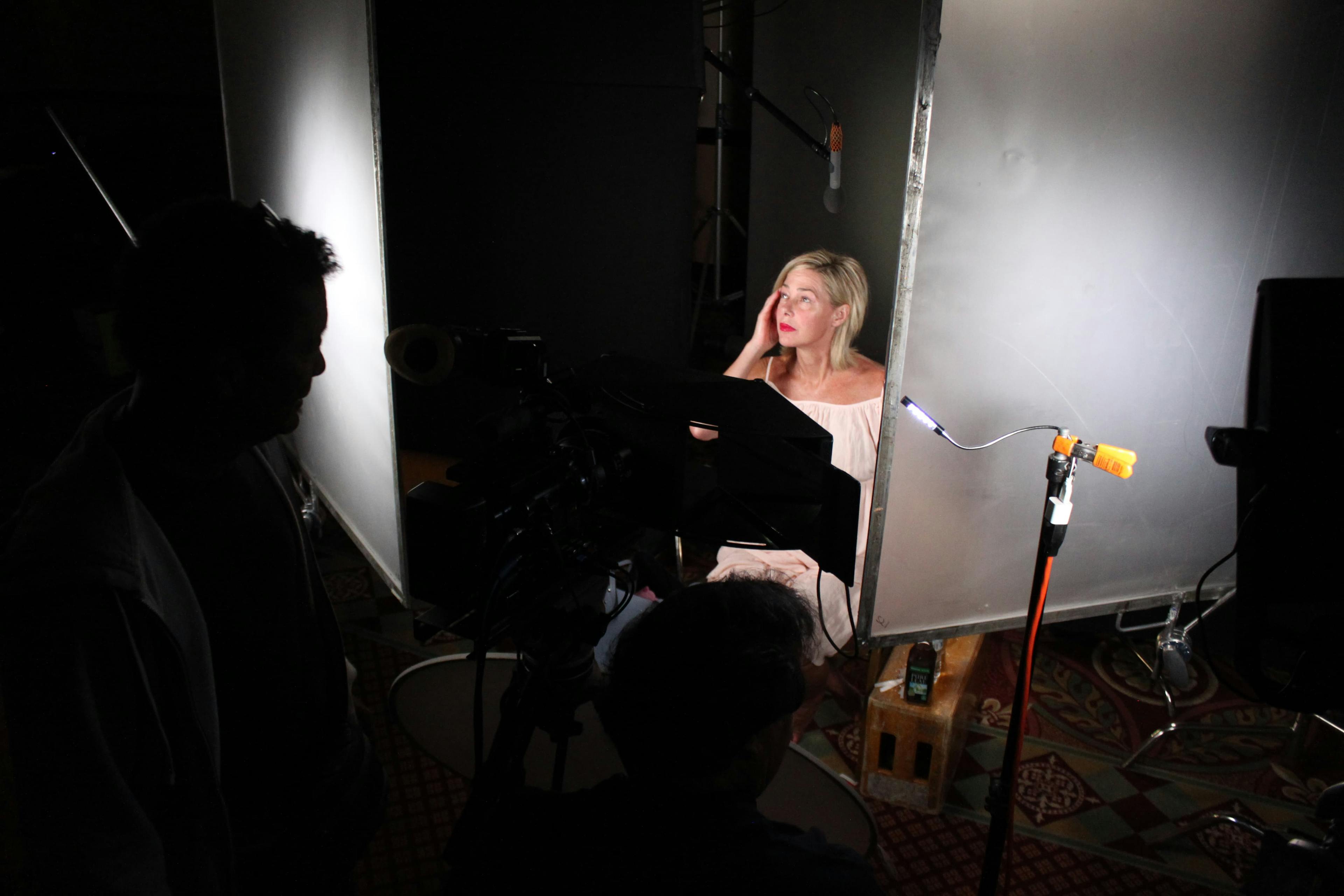Woman sitting in studio lights