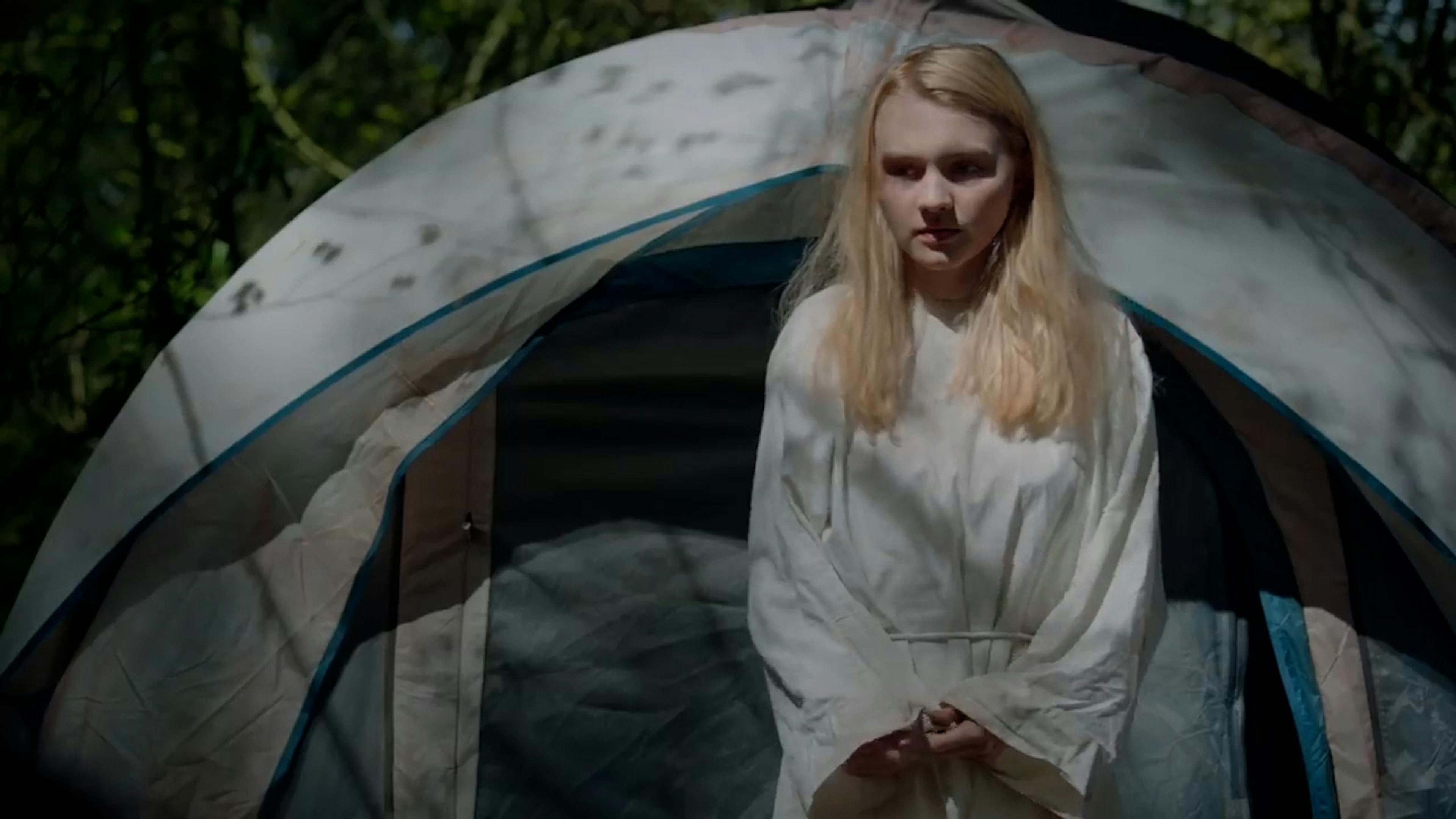 Woman standing in front of tent