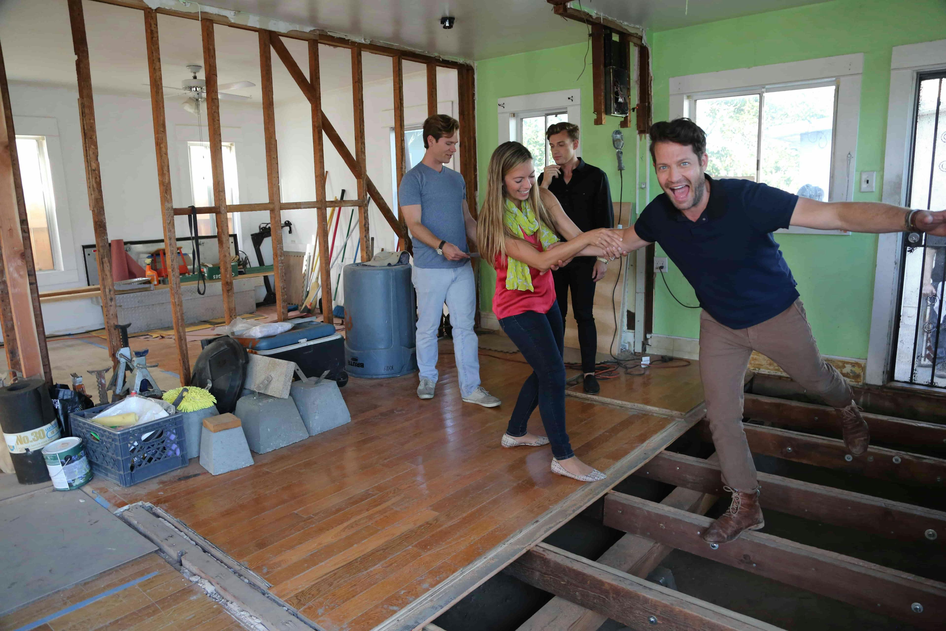 Man walking on floor with floorboards missing