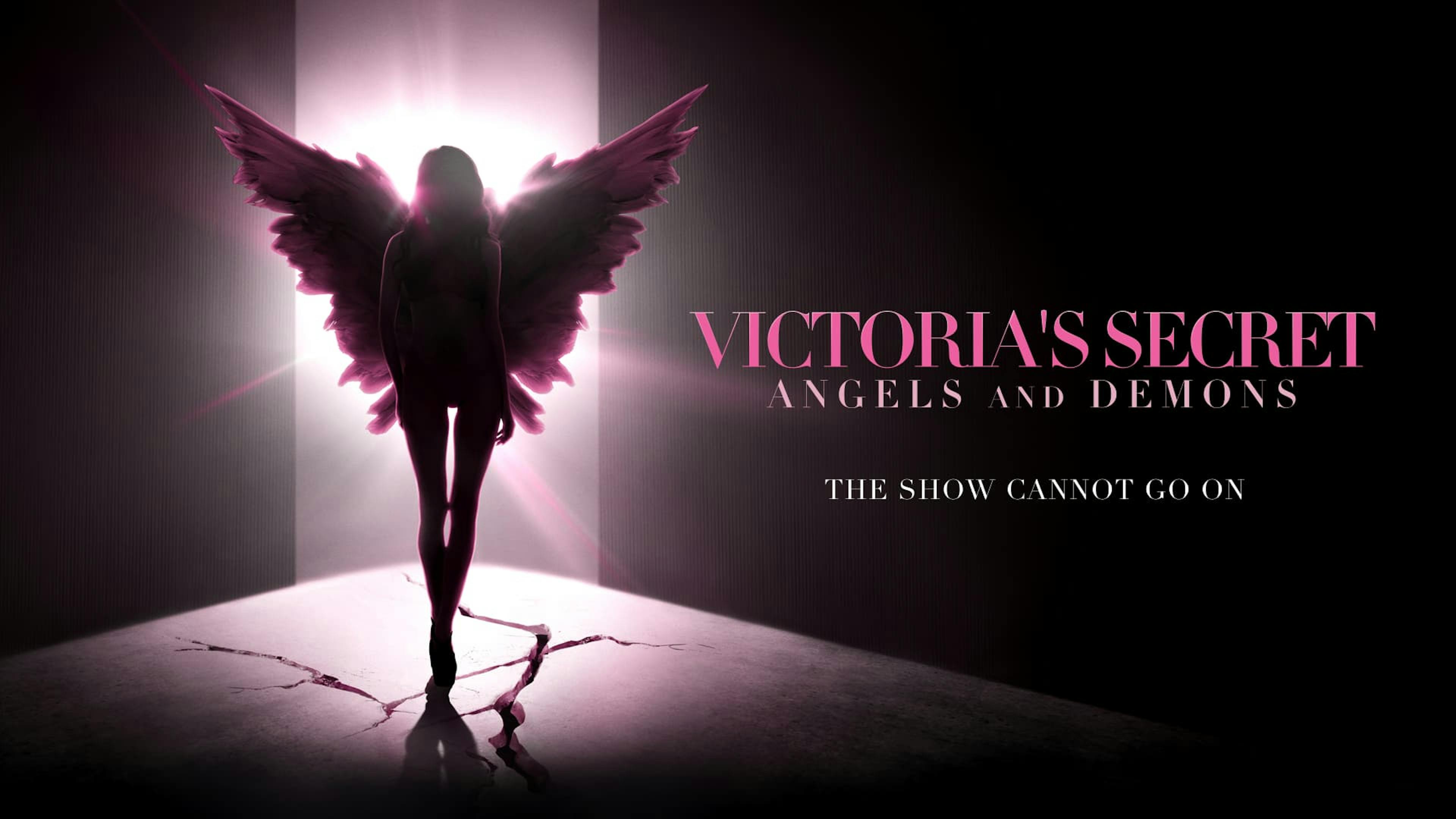 Girl wearing angel wings in dim lighting
