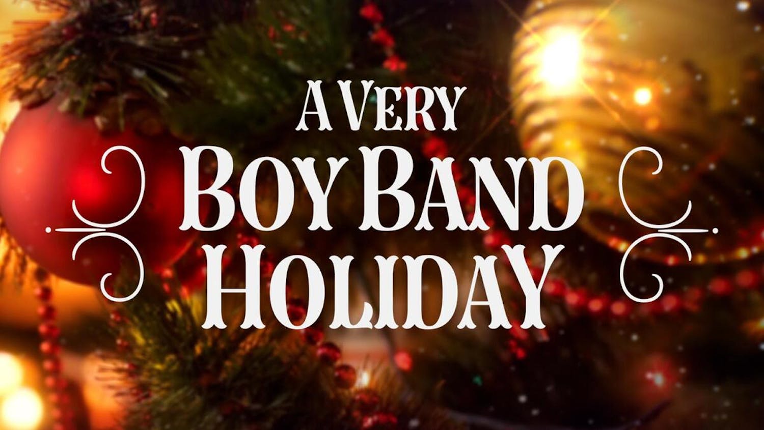 A very boyband holiday logo over Christmas baubles