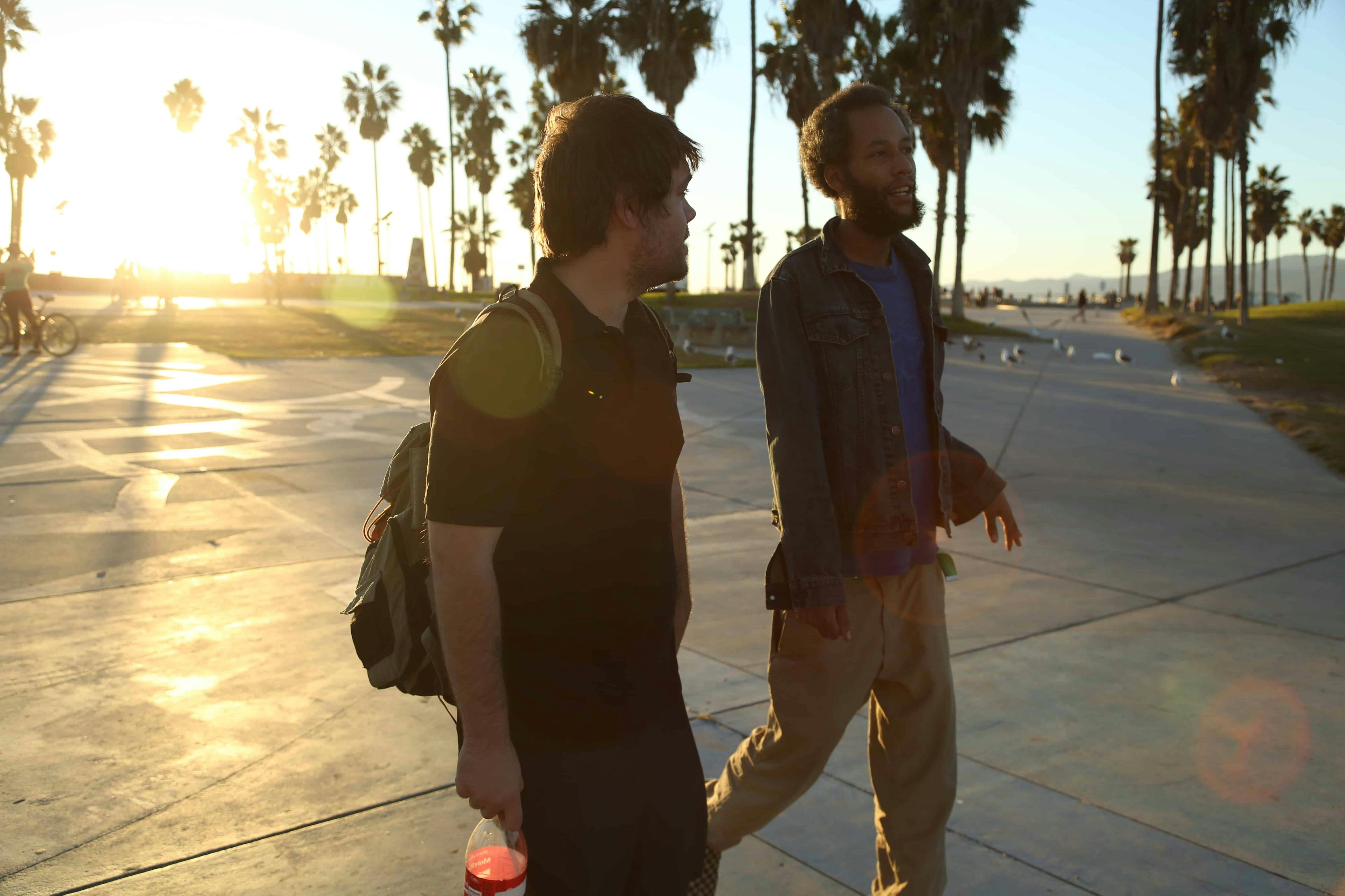 Two men walking and talking
