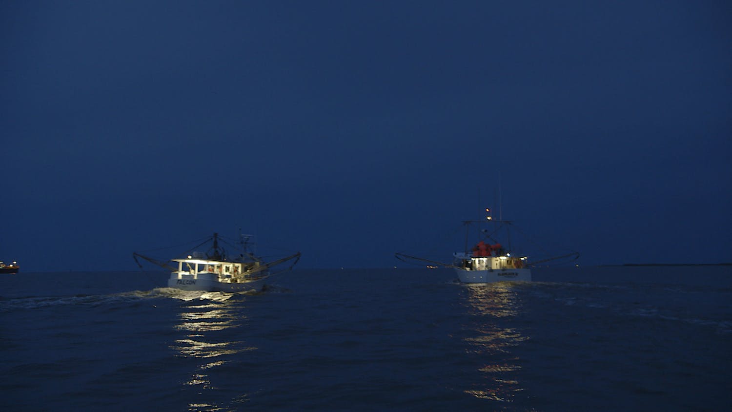 Two boats at sea in nighttime