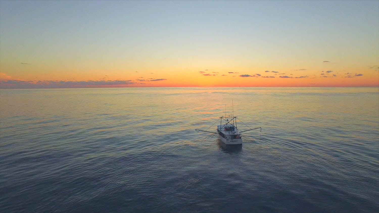 Fishing boat at sea during sunset