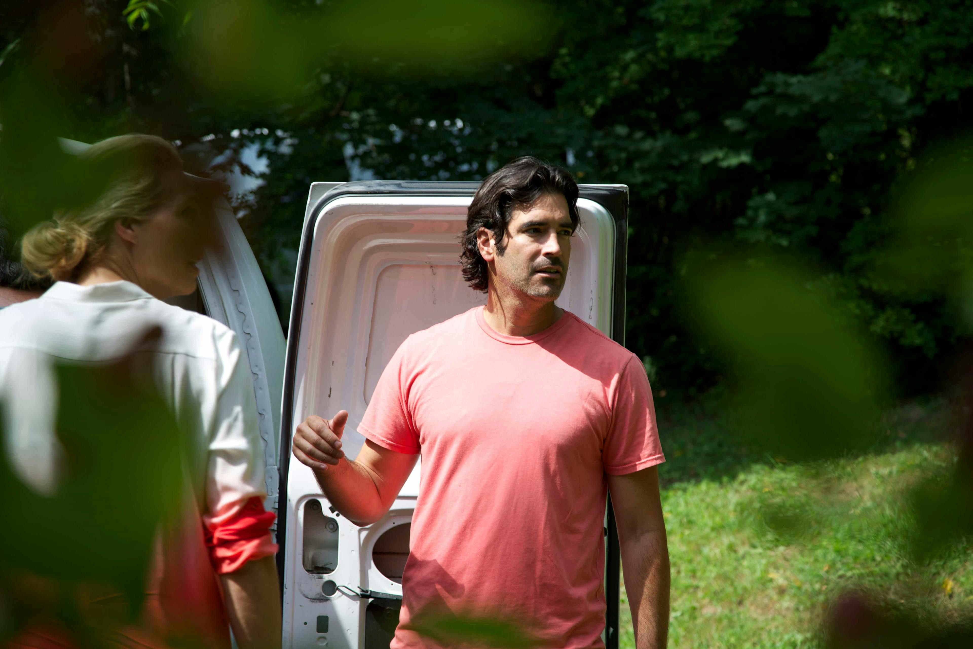 Man and woman stood at back of van