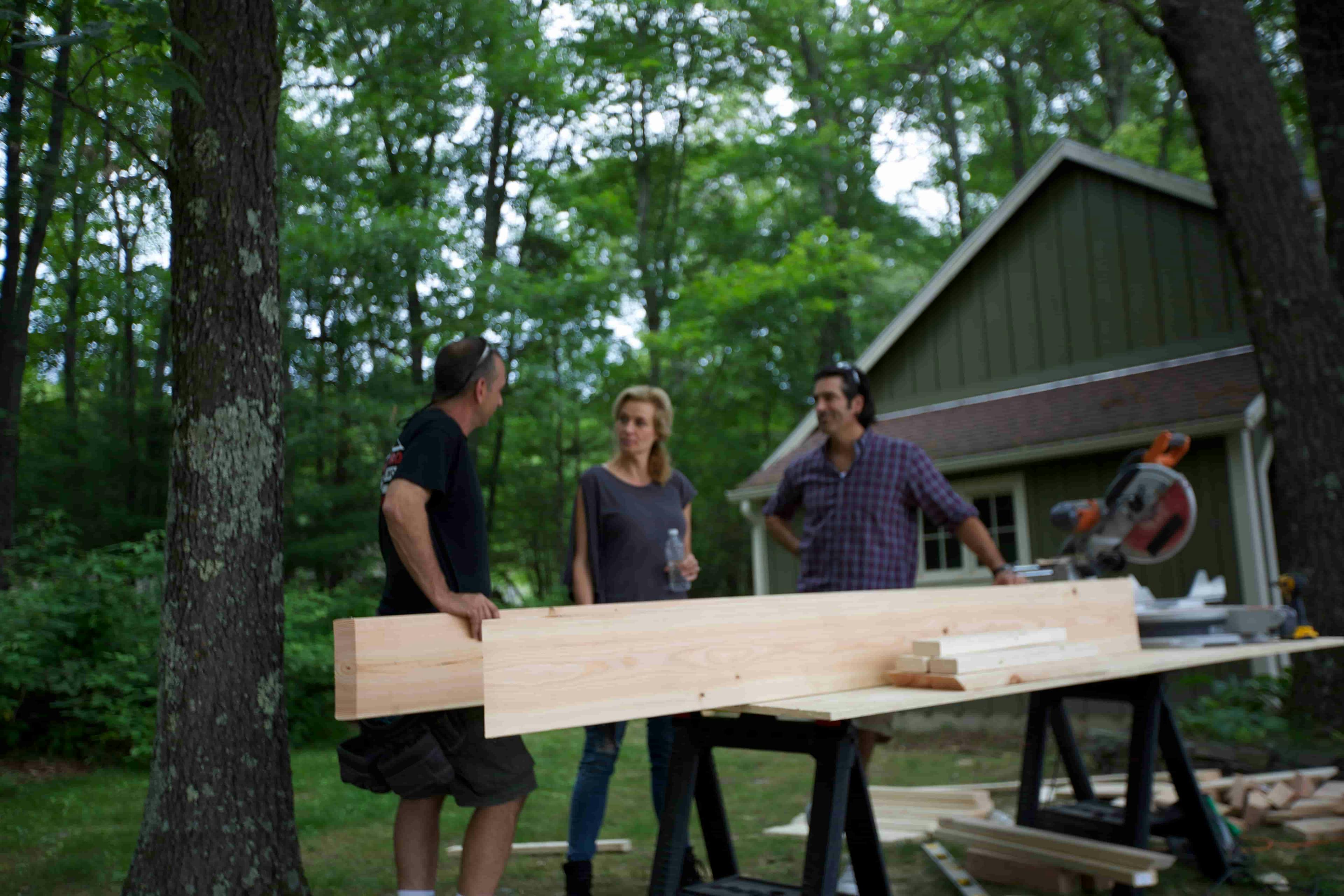 Plank of wood being moved into house