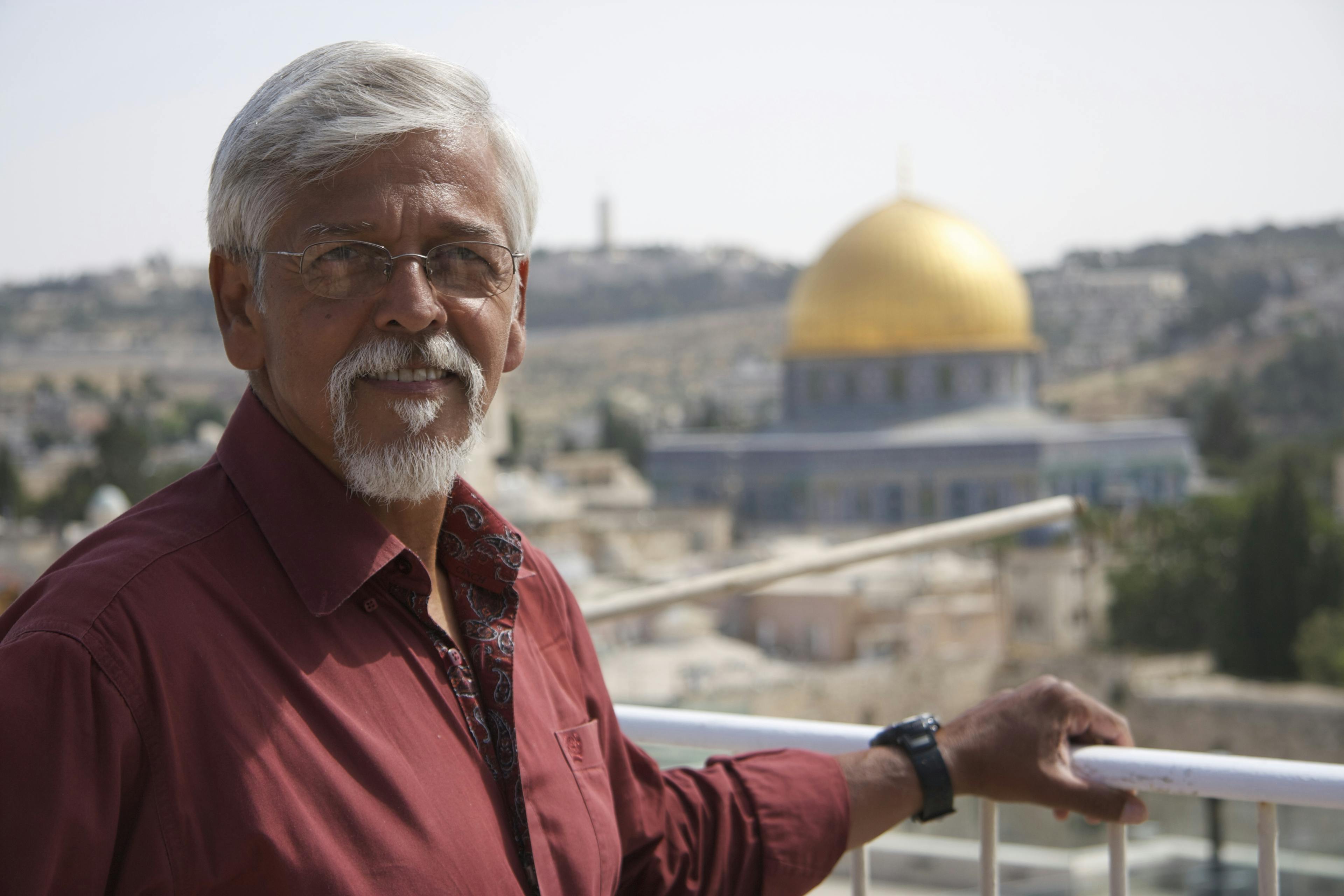 Man stood in front of old building
