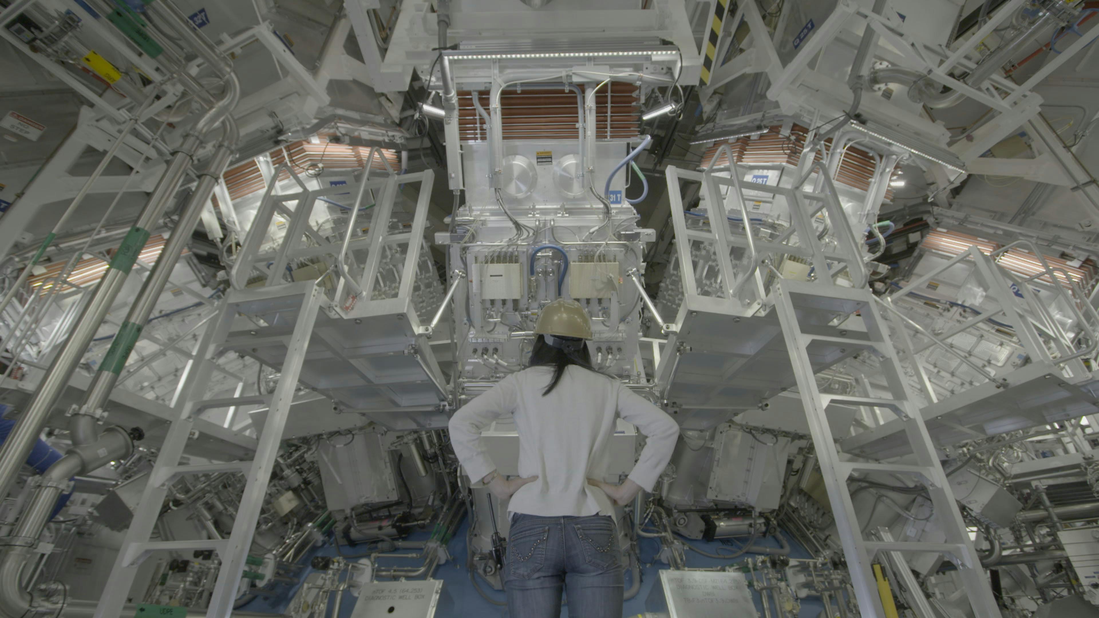 Woman looking up at machinery