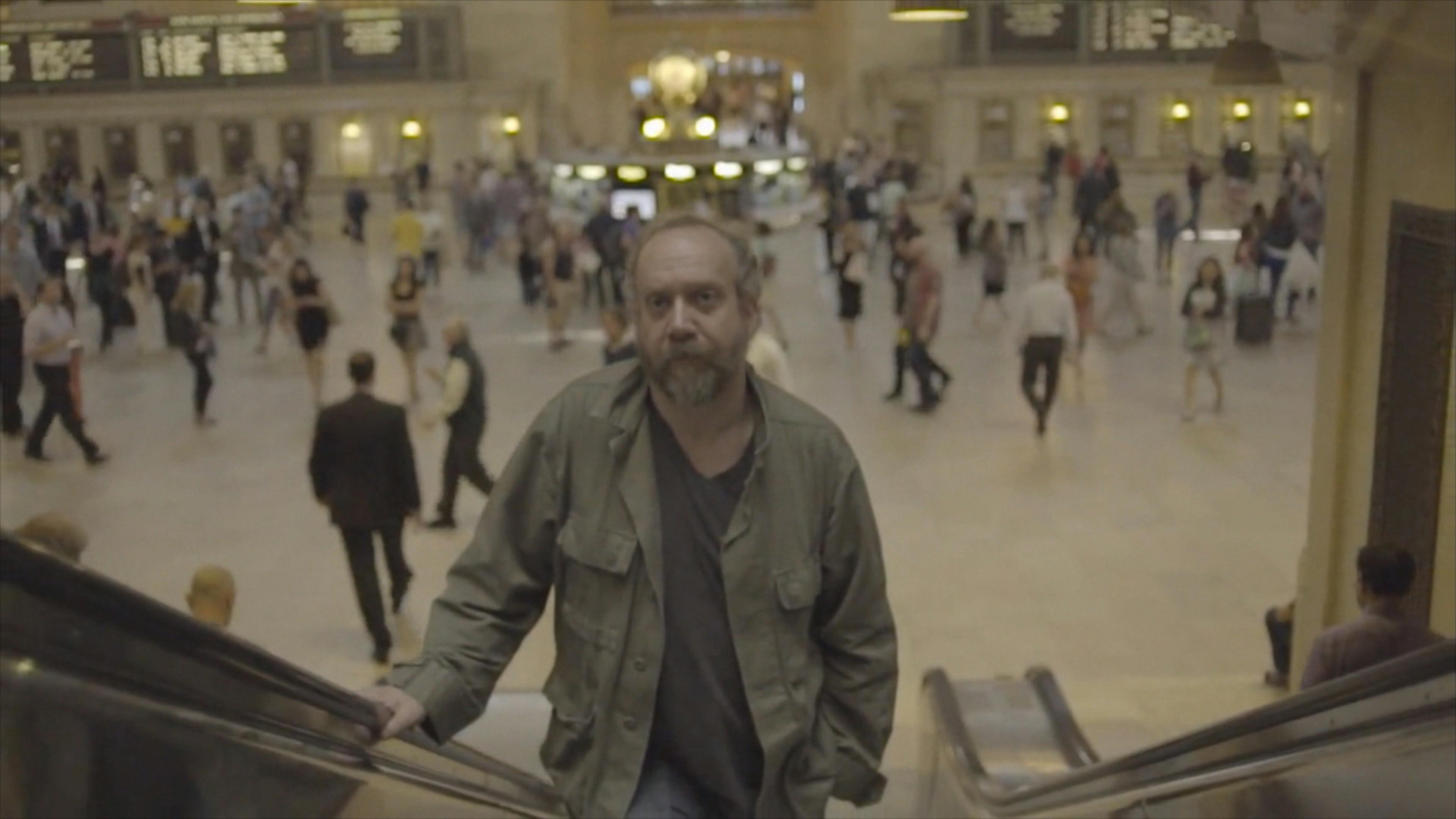 Man going up escalator