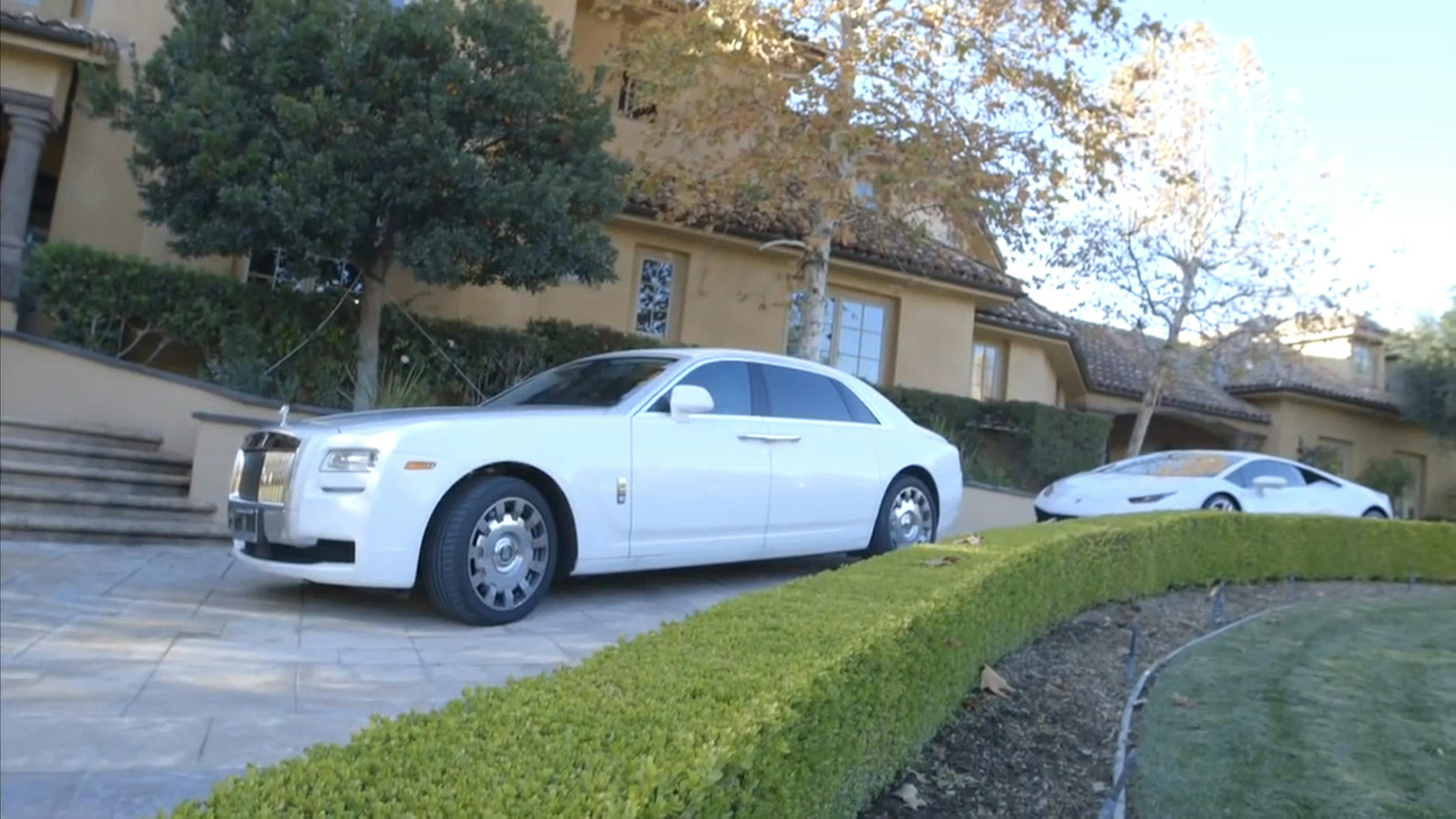 Two white cars outside house