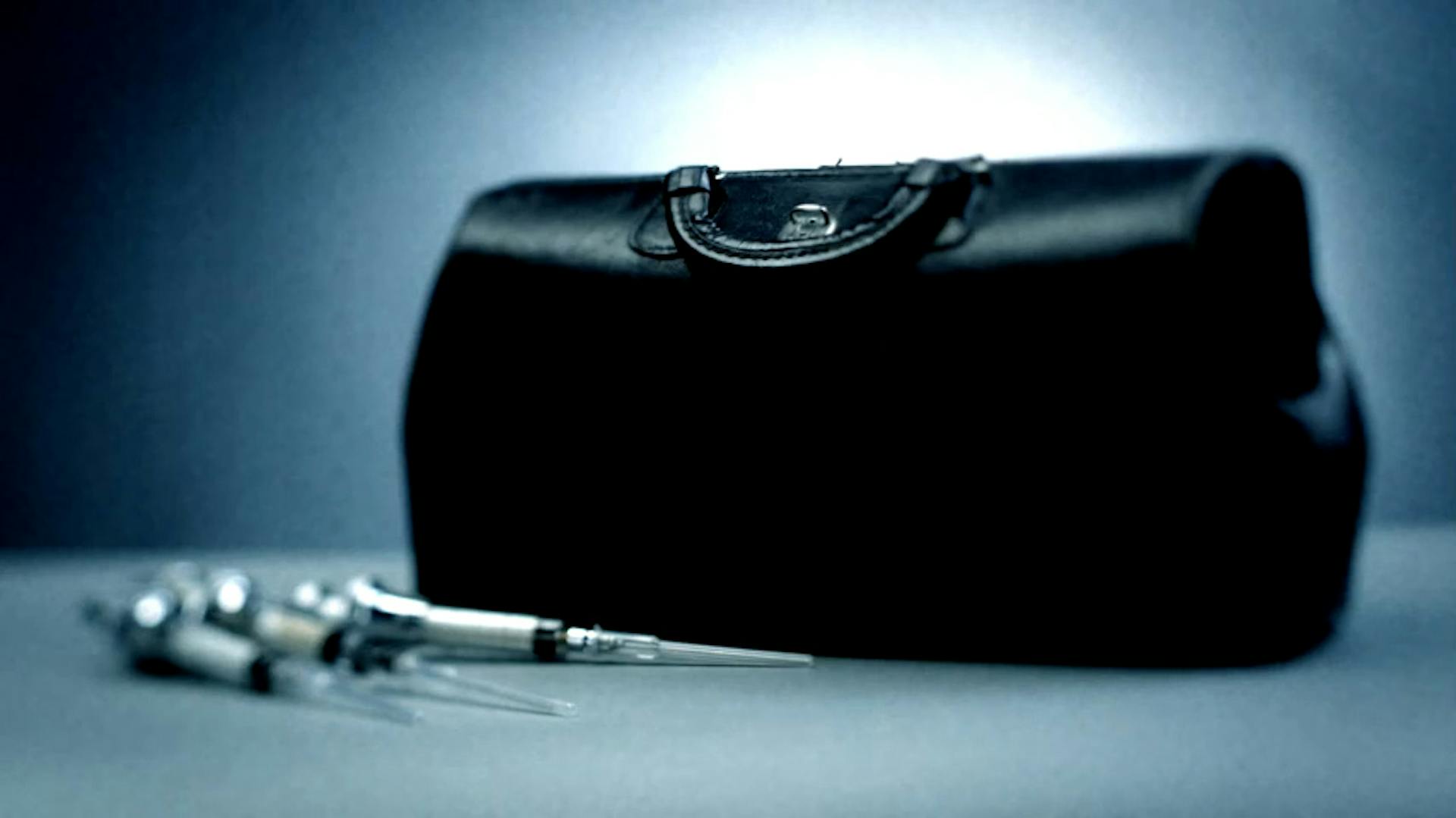 Needles next to medical bag