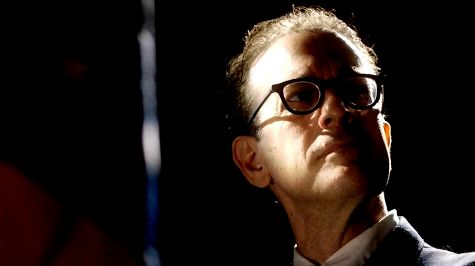 Man with glasses looking in thought